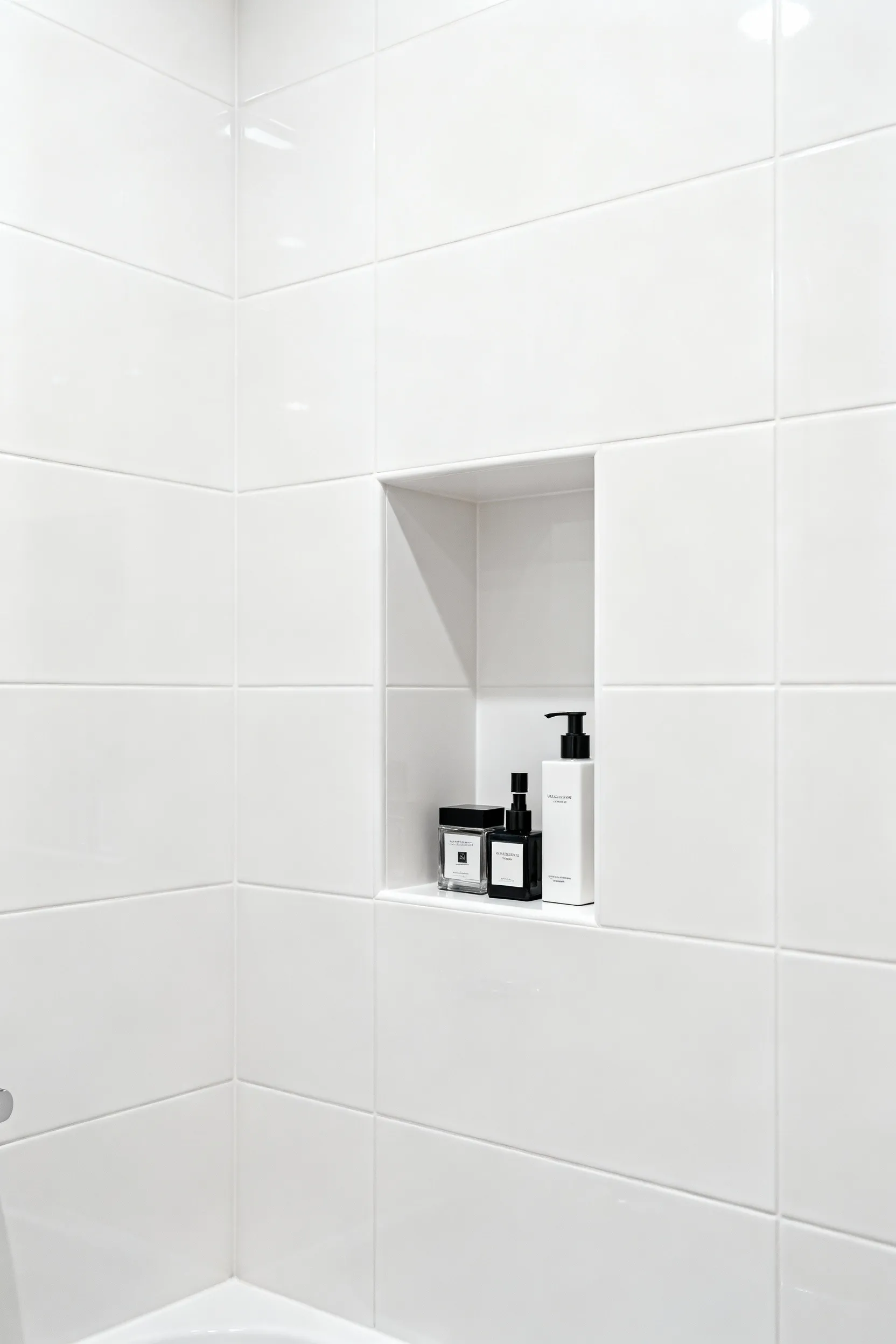 Small modern bathroom with a built-in recessed shower niche showcasing minimalist, integrated storage for a clean and uncluttered look.