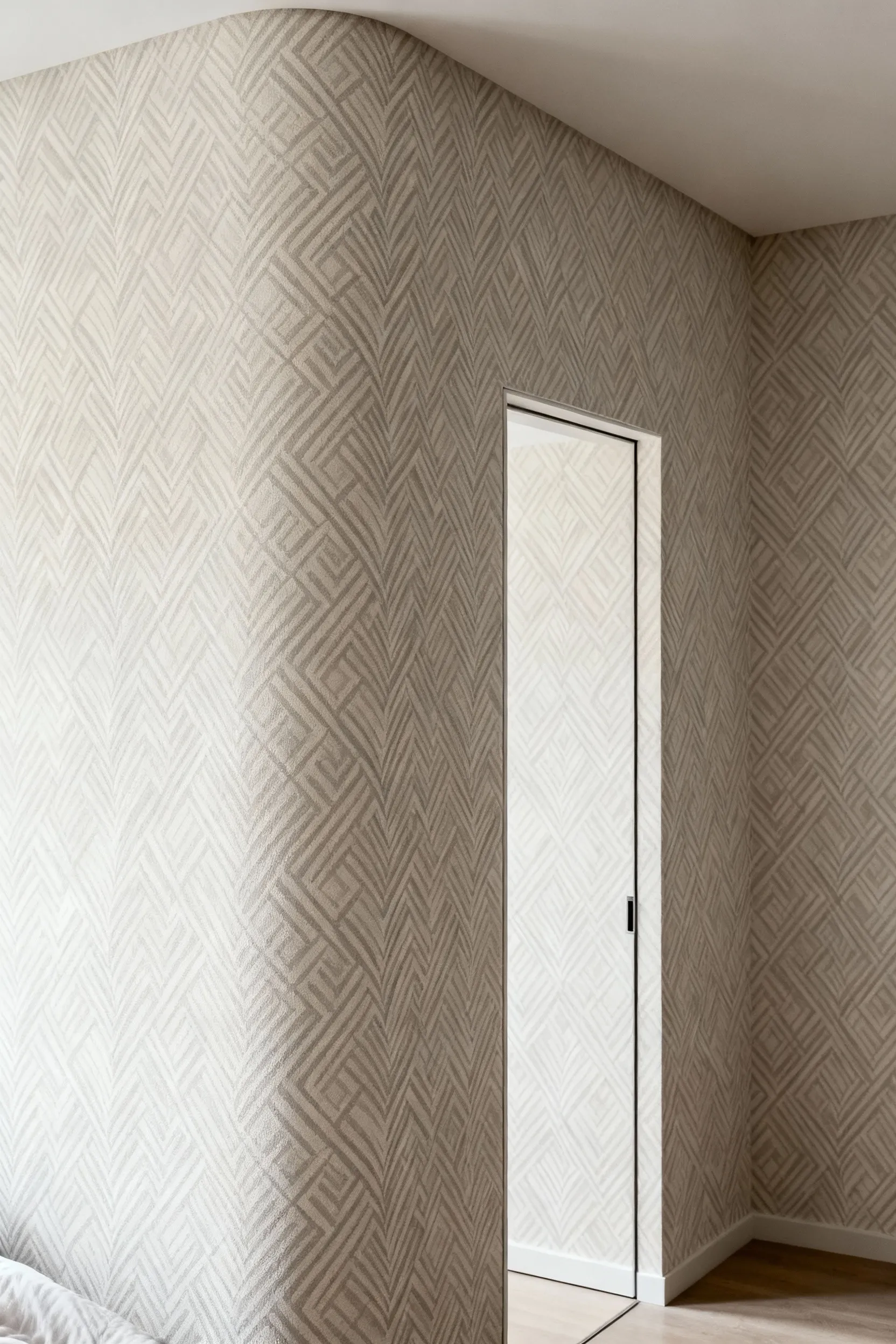 Modern bedroom featuring a subtle patterned wallpaper seamlessly transitioning across a corner and around a doorway, creating a cohesive wall-to-wall integration, well-lit with natural light.