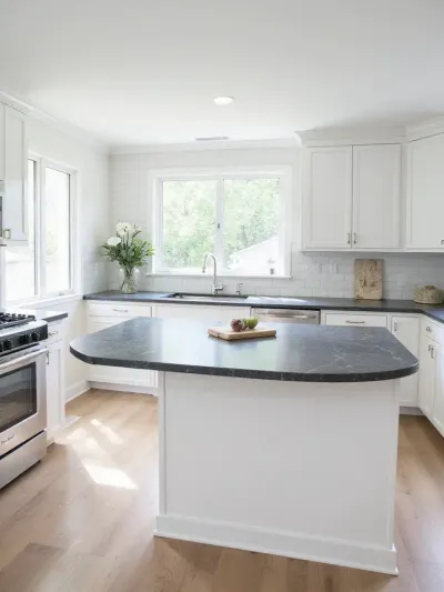 Modern kitchen design with white shaker cabinets and dark gray quartz countertops