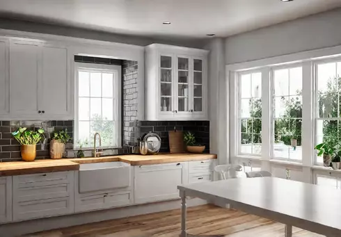 A bright and airy modern farmhouse kitchen featuring white shaker cabinets afeat